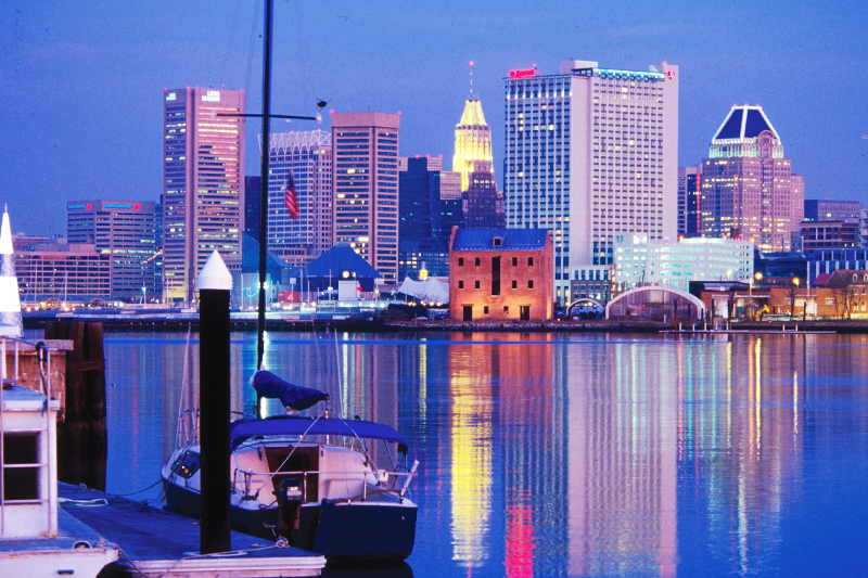 A nighttime view of Baltimore City skyline scross the Inner Harbor