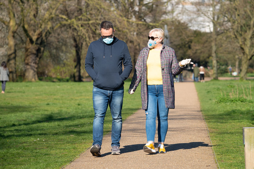 Photo of older man and woman walking on a path